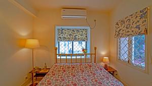 a bedroom with a bed and a window at Yellowbrick - Calcutta's Freshest BnB in Kolkata
