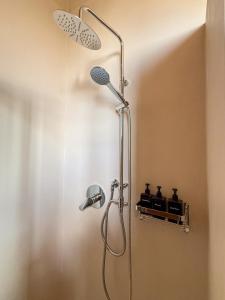 a shower with a shower head in a bathroom at La Regina Guest Room in Madonna della Scala +13 photos