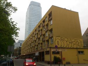 a building with graffiti on it on a city street at Apartament Saski in Warsaw