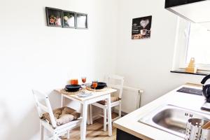 a kitchen with a small white table and chairs at Wohnung in Siegen in Wilnsdorf