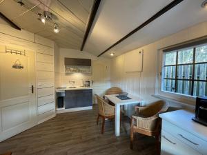 a kitchen with a table and chairs in a room at Ferienhaus Walddomizil in Neustadt-Glewe