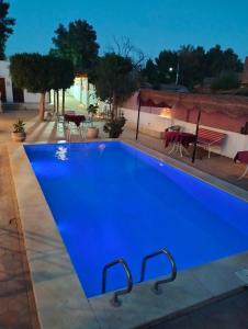 een groot blauw zwembad 's nachts bij Villa River Nile in Al Qurnah