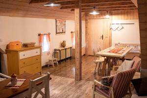 a kitchen and dining room with a table and chairs at Cifrovaná drevenička in Detva