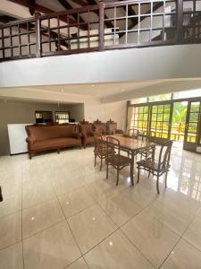 a living room with a table and chairs and a couch at In Villa Garden Resort in Batu