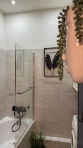 a bathroom with a shower with a glass door at Zapisane w Cegle by LibertaRent in Świdnica +7 photos