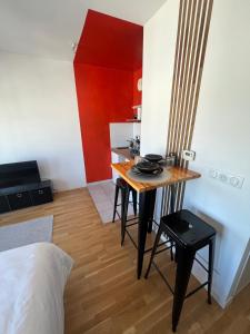 a small kitchen with a table in a room at calme en plein centre in Drancy