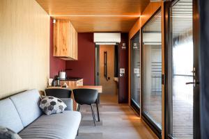 a living room with a couch and a kitchen at Rummu Holiday Home in Rummu