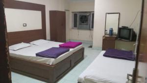 Letto o letti in una camera di Hotel Sangam sagar