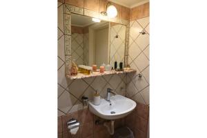a bathroom with a sink and a mirror at Polymnia's Home in Áyios Andónios