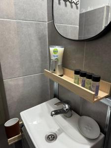 a bathroom with a sink and a mirror and a mirror at C spot in Larisa