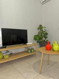 a living room with a flat screen tv on a table at C spot in Larisa +6 photos