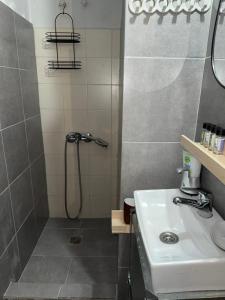 a bathroom with a shower and a sink at C spot in Larisa