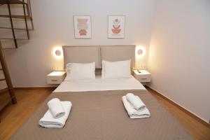 a bedroom with a bed with two towels on it at Liora Retreat in Kavála