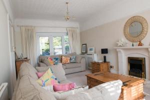 a living room with a couch and a fireplace at Mumbles Seaside sleeps up 11 Pets allowed in Swansea