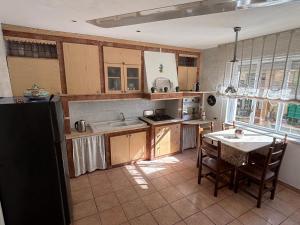 a kitchen with a sink and a table with chairs at AcasaMy in Naples