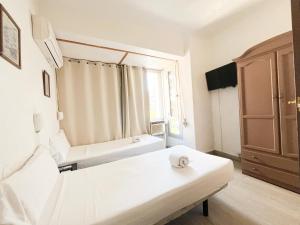Postel nebo postele na pokoji v ubytování LÀtic Rooms