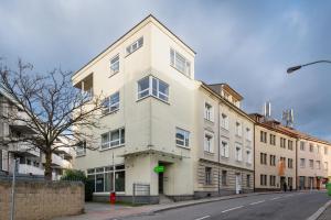 a large white building on a city street at Veleslavin Apartments in Prague