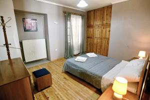 a bedroom with a bed and a dresser and a window at Prokopis House in Sívros +6 photos