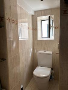 a small bathroom with a toilet and a window at la bella de plaza mayor in Madrid
