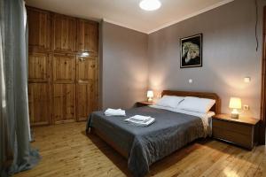 a bedroom with a bed with two night stands and two lamps at Prokopis House in Sívros