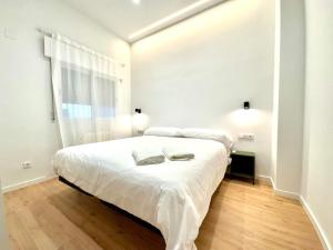 een witte slaapkamer met een groot bed en een raam bij Azahar Homes - Murcia Centro in Murcia