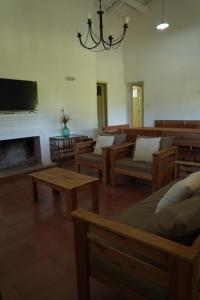 a living room with couches and tables and a fireplace at Quinta San Miguel in Concordia