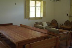 a living room with a wooden table and a couch at Quinta San Miguel in Concordia +16 photos