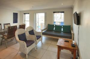 a living room with a couch and chairs and a table at Voorschoten in Langebaan