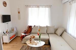 a living room with a couch and a table at Apartman ANDRIJA in Bileća