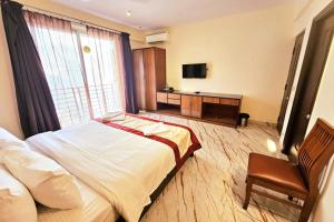 Postel nebo postele na pokoji v ubytování Hotel Jubilant
