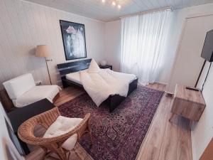 a bedroom with a bed and a chair and a couch at Oase in Hürth