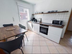 a kitchen with a table and a table and a microwave at Oase in Hürth
