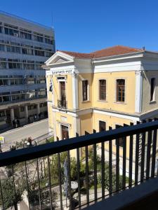 a yellow building on the side of a street at POST VIEW Center Luxury Apartments 4 in Ioannina