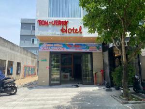 a building with a sign that reads too happy hotel at Tom and Jerry Hotel in Danang