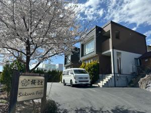 a white van parked in front of a house at SAKURA FUJI in Fujikawaguchiko