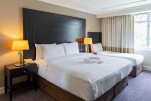 Katil atau katil-katil dalam bilik di Shamrock Lodge Hotel