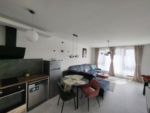 a kitchen and living room with a couch and a table at Sea view luxury appartment-parking in Varna City