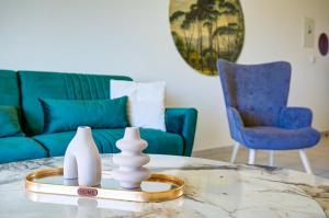 a living room with a table with two vases on it at Royal Seacrest amazing location 2 Bed Apartment by VICHY Holidays in Paphos