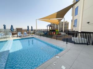 a swimming pool on the roof of a building at Al Hamra Village Marina Residences in Ras al Khaimah