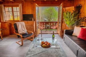 a living room with a couch and a glass table at Chalet aux Portes du Soleil avec balcon in Val-d'Illiez +47 photos