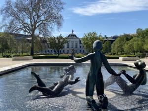 a statue of two children swimming in a fountain at Art Design Gallery - Bratislava city center in Bratislava
