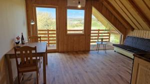 a dining room with a table and a large window at Apartmany Nemo in Nemotice