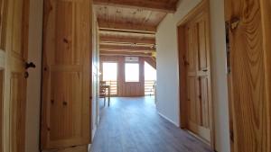 an empty hallway with wooden floors and doors at Apartmany Nemo in Nemotice