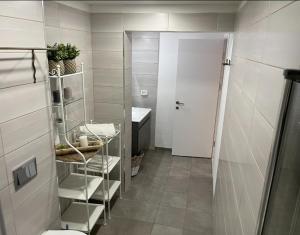 a bathroom with a toilet and a sink and a door at Welcome to Sunshine in Migdal +4 photos