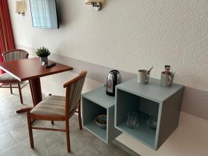 a dining room with a table and a chair and a table and a tableablish at Gästehaus Tilly in Hannoversch Münden