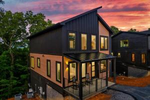 a black house with a lot of windows at Spring Splash Retreat - Pool Hot Tub & Games in Catlettsburg