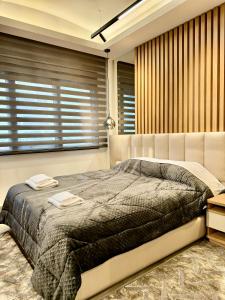 a bedroom with a bed with two towels on it at Velvet Aura Edessa in Edessa