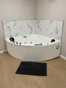 a white bath tub in a room with a black rug at Alicante 30 in Alicante +15 photos