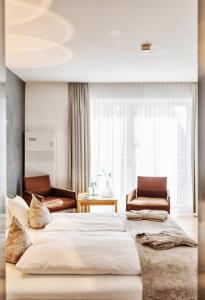 Postel nebo postele na pokoji v ubytování Seevital Hotel & SPA - Ihr 4 Sterne Superior Hideaway direkt am See