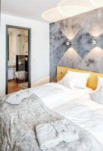 Postel nebo postele na pokoji v ubytování Seevital Hotel & SPA - Ihr 4 Sterne Superior Hideaway direkt am See